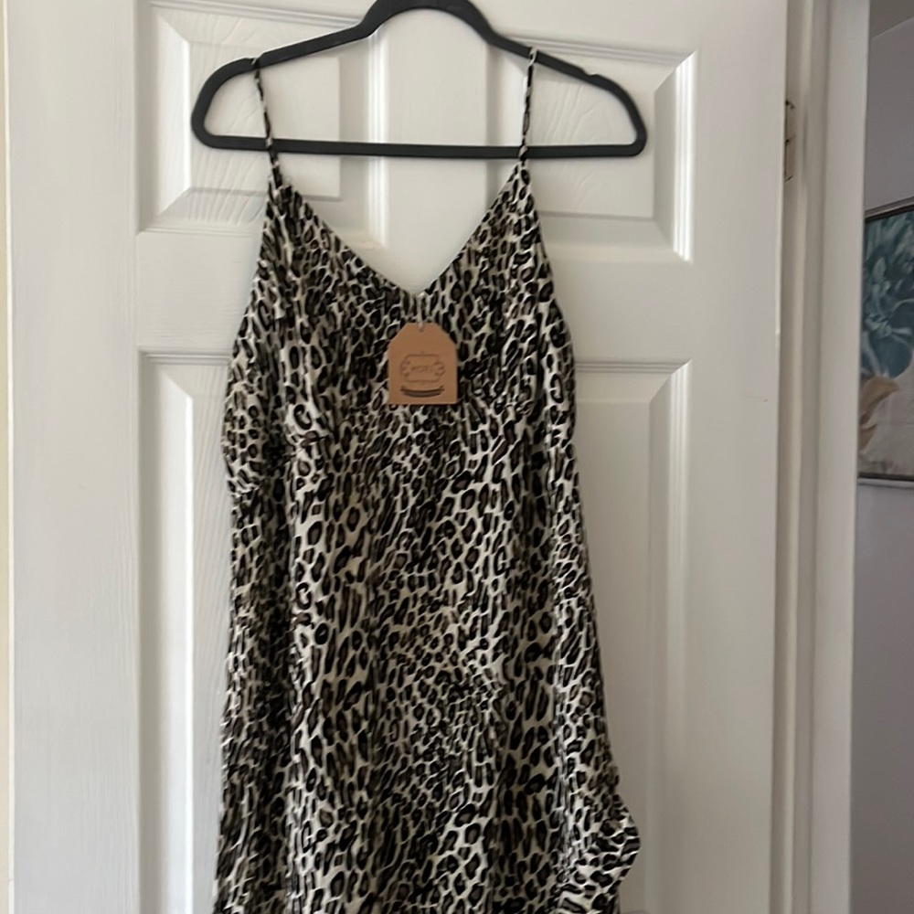Never worn leopard dress. Shorter in front longer in back